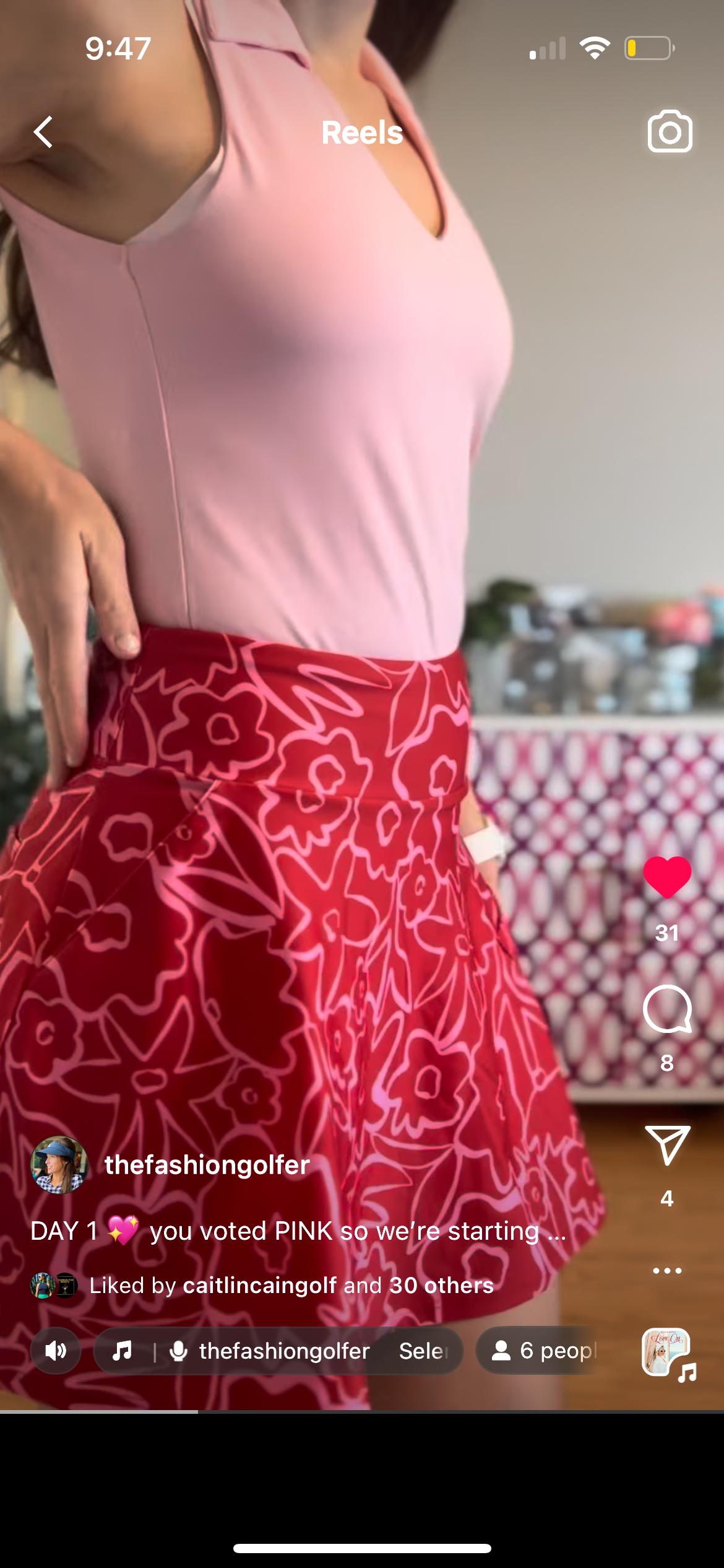 woman wearing emyvale golf skirt in red floral edge